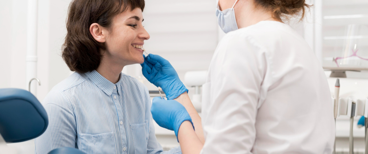 Orthodontist carefully examining a patient's teeth to monitor progress during orthodontic treatment.