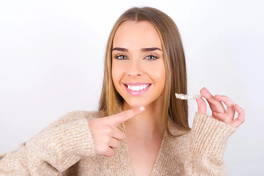 Young adult considering Invisalign treatment with a focus on convenient payment plans