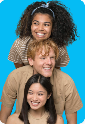 Three people are stacked in a playful pose against a blue background, all smiling and looking to the side.