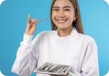 A woman in a white coat holds a dental tool and a tray of dental instruments against a blue background.
