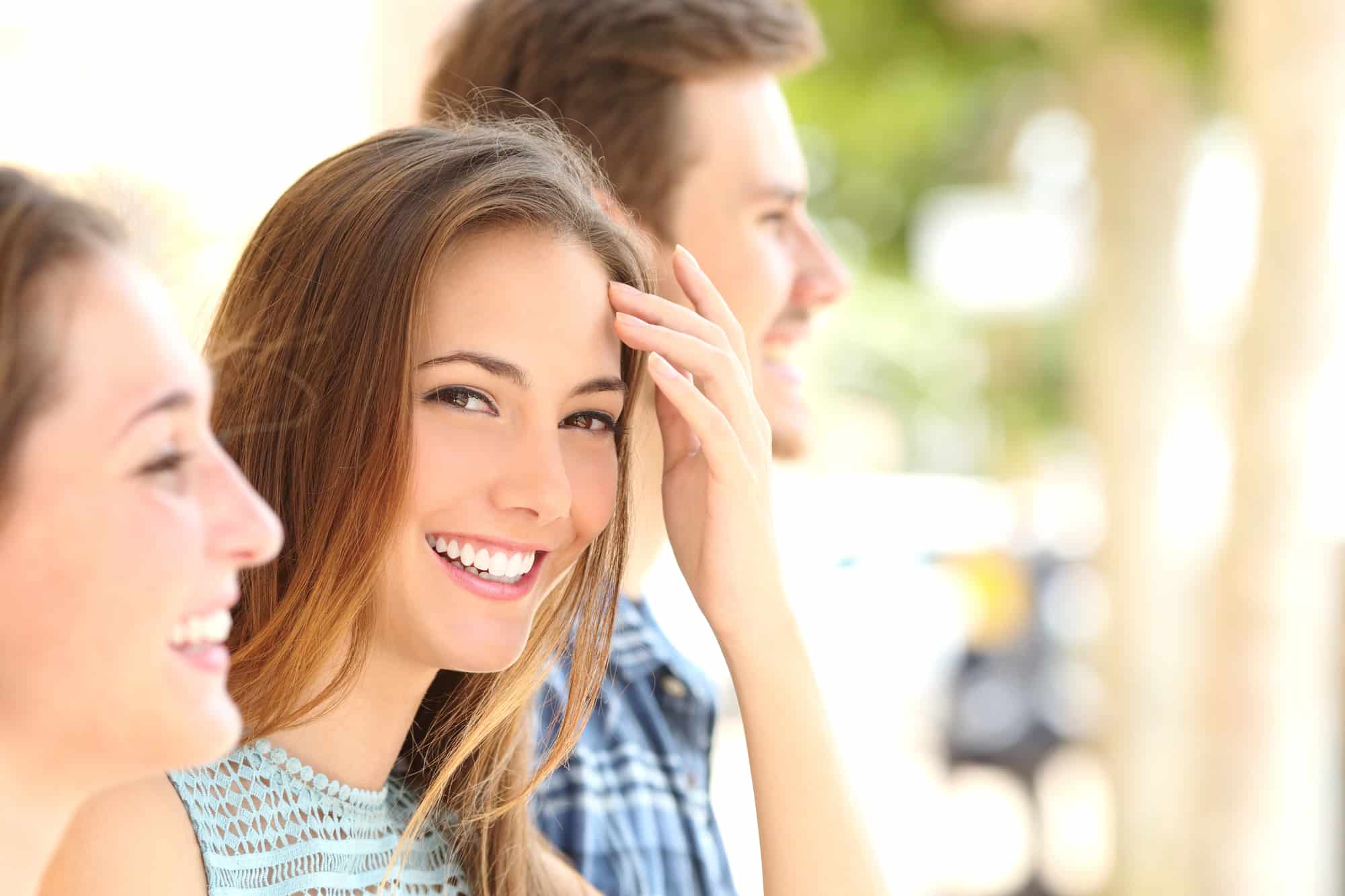 Teenager smiling while undergoing orthodontic treatment with a Herbst appliance