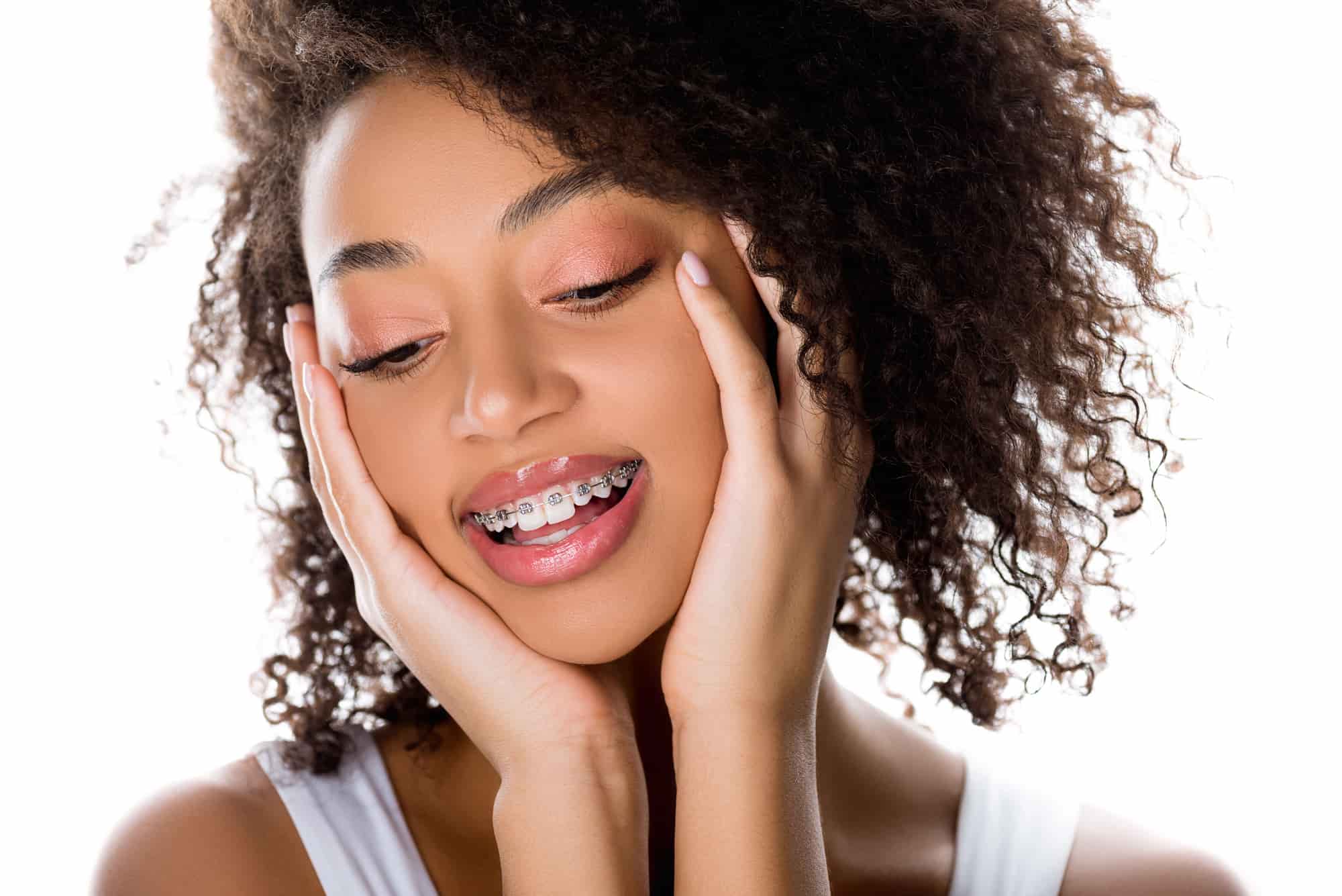 Happy young adult with braces posing for a selfie, embracing their orthodontic journey