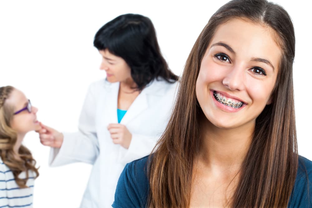 Best Orthodontics Smiling young adult learning about affordable braces cost solutions at a clinic